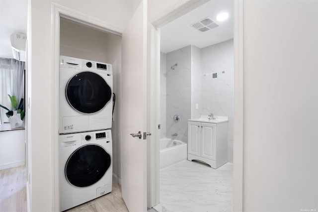 washroom featuring stacked washer and dryer