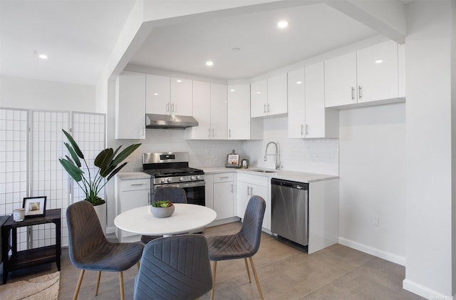 kitchen featuring backsplash, sink, white cabinets, and appliances with stainless steel finishes