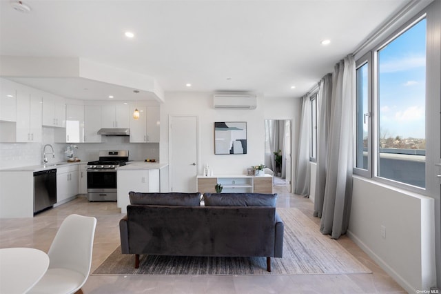 living room with a wall mounted AC and sink