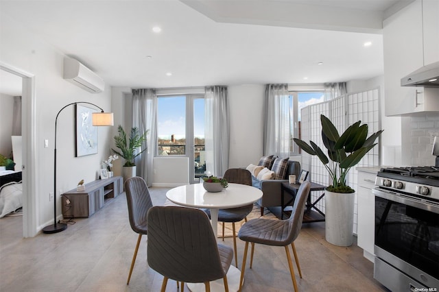 dining room featuring recessed lighting, a wall unit AC, plenty of natural light, and baseboards