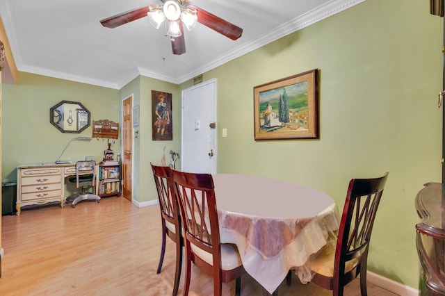 dining space with light hardwood / wood-style floors, ceiling fan, and crown molding