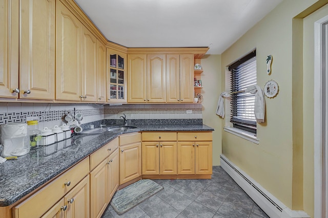 kitchen featuring decorative backsplash, light brown cabinetry, sink, and a baseboard heating unit