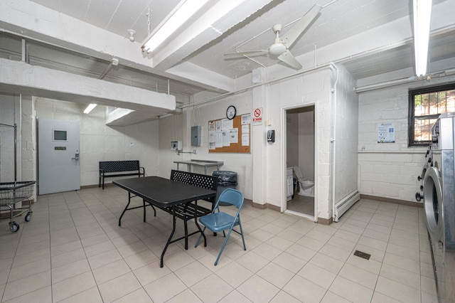 tiled dining area featuring electric panel, ceiling fan, and a baseboard heating unit