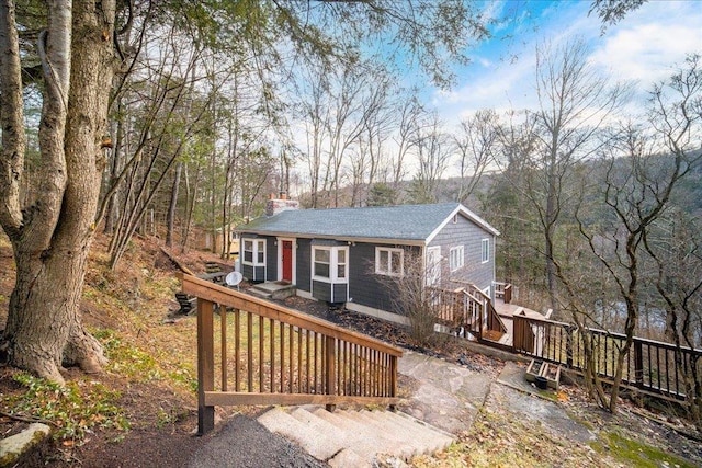 rear view of property featuring a wooden deck