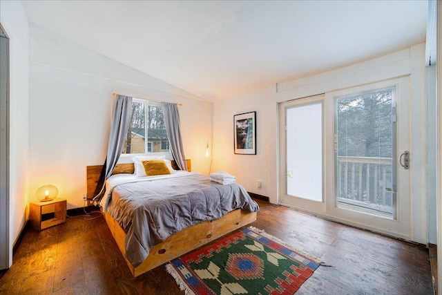 bedroom with access to outside, dark hardwood / wood-style floors, and lofted ceiling