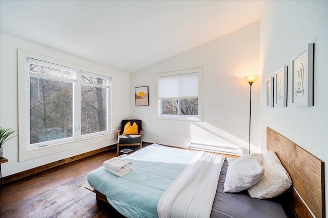 bedroom with dark hardwood / wood-style floors, a baseboard radiator, and lofted ceiling