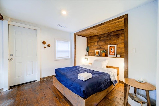 bedroom featuring dark hardwood / wood-style flooring