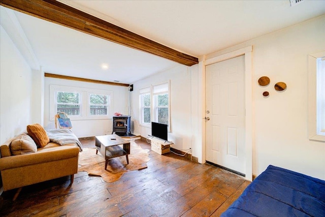 living room featuring ornamental molding, a wood stove, and dark wood-type flooring