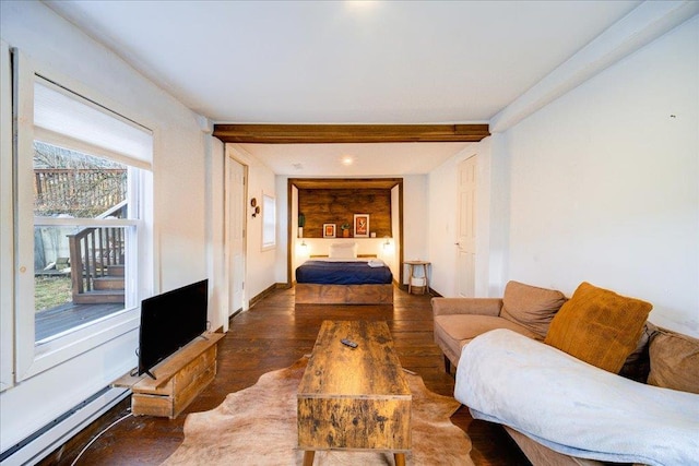 bedroom with dark wood-type flooring and a baseboard heating unit