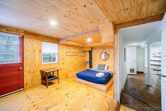 bedroom featuring wood walls, hardwood / wood-style floors, and wooden ceiling