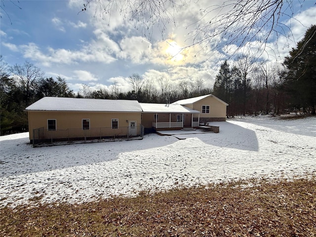 view of snow covered rear of property