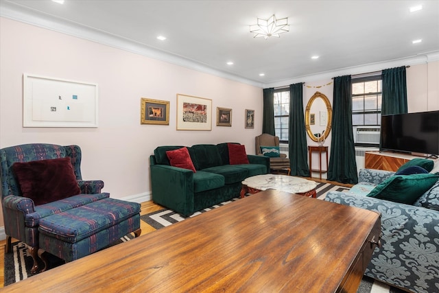 living room with light hardwood / wood-style flooring and crown molding