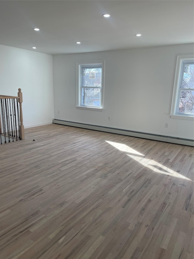 basement with a baseboard radiator and light wood-type flooring