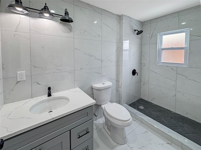 bathroom with tiled shower, vanity, toilet, and tile walls