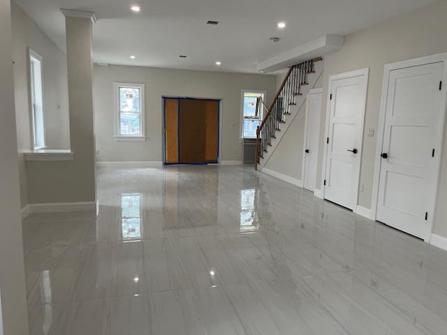 unfurnished room featuring plenty of natural light