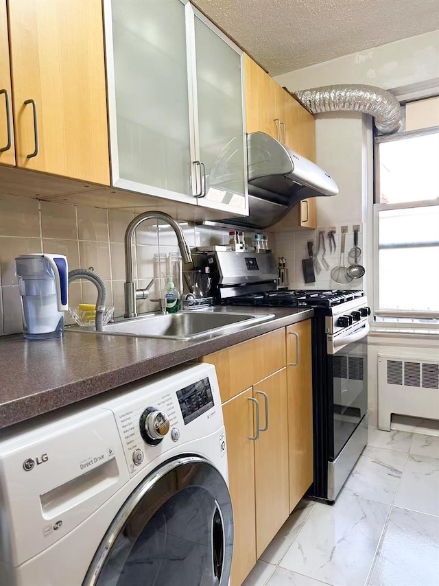 kitchen with washer / dryer, radiator, gas stove, and tasteful backsplash