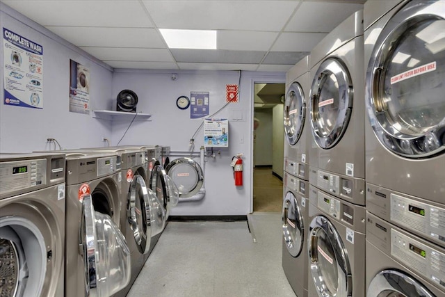 laundry area featuring stacked washer / drying machine