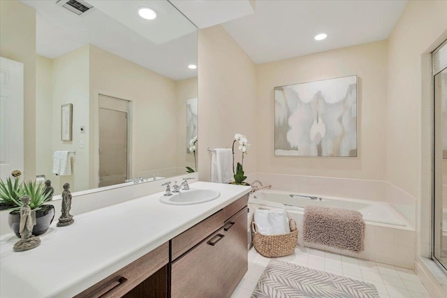 bathroom with vanity, plus walk in shower, and tile patterned flooring