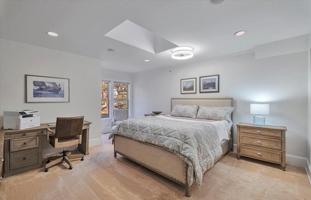 bedroom featuring a skylight and light colored carpet