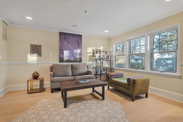 living area with hardwood / wood-style floors and ornamental molding