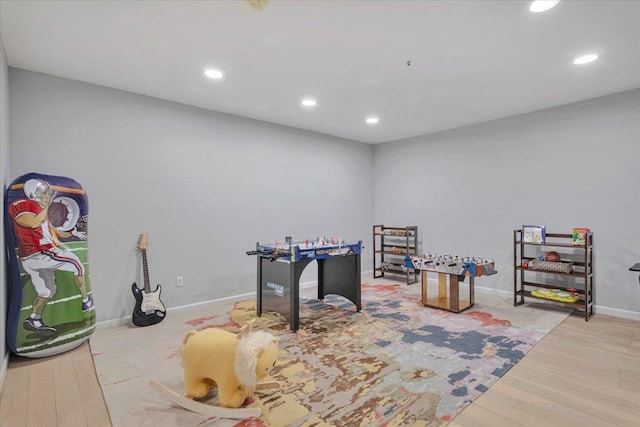 rec room with light wood-type flooring