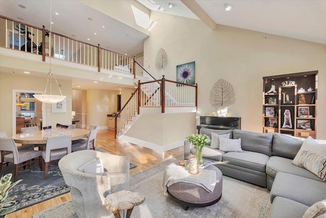 living room featuring light hardwood / wood-style flooring and high vaulted ceiling