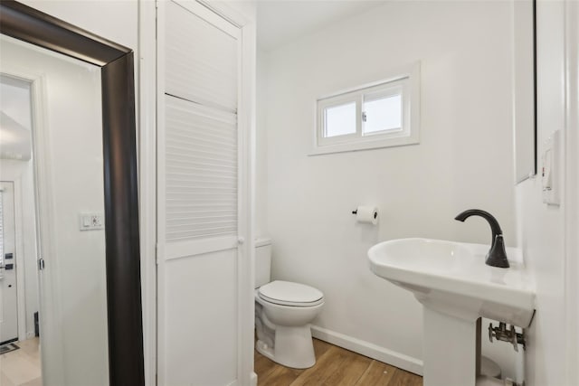 bathroom featuring sink, wood-type flooring, and toilet