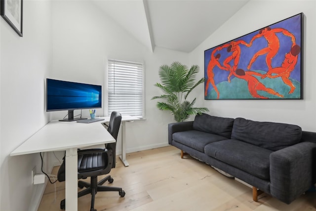 office with light hardwood / wood-style floors and vaulted ceiling