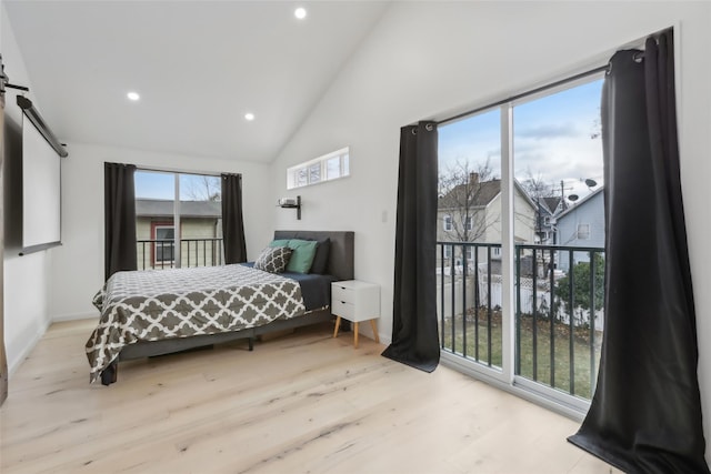 bedroom with high vaulted ceiling and light hardwood / wood-style flooring