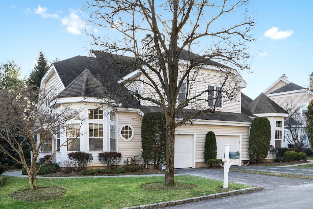 view of front of property featuring a front yard and a garage