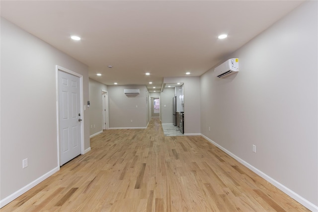 interior space with light wood-type flooring and an AC wall unit