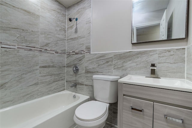 full bathroom with vanity, tiled shower / bath combo, tile walls, and toilet