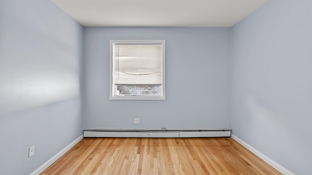 unfurnished room with light hardwood / wood-style flooring and baseboard heating