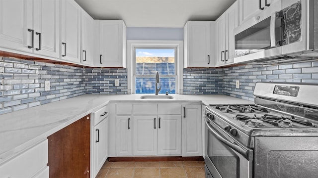 kitchen with white cabinets, stainless steel appliances, and sink