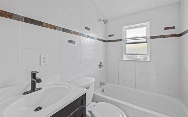 full bathroom featuring tile walls, toilet, vanity, and tiled shower / bath combo