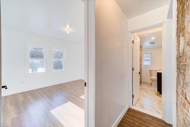 corridor featuring dark hardwood / wood-style floors