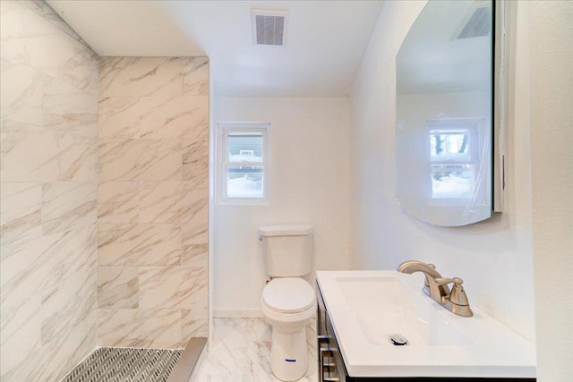 bathroom featuring vanity, toilet, and walk in shower