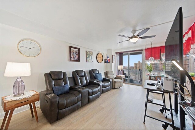 living room featuring light hardwood / wood-style floors and ceiling fan