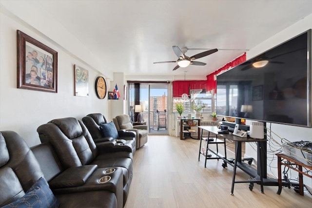 living room with ceiling fan and light hardwood / wood-style floors