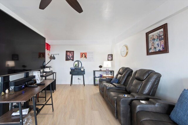 living room featuring ceiling fan and light wood-type flooring