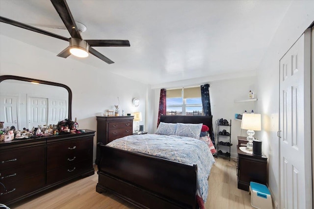 bedroom with light hardwood / wood-style floors and ceiling fan