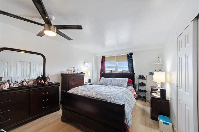 bedroom with light hardwood / wood-style floors and ceiling fan