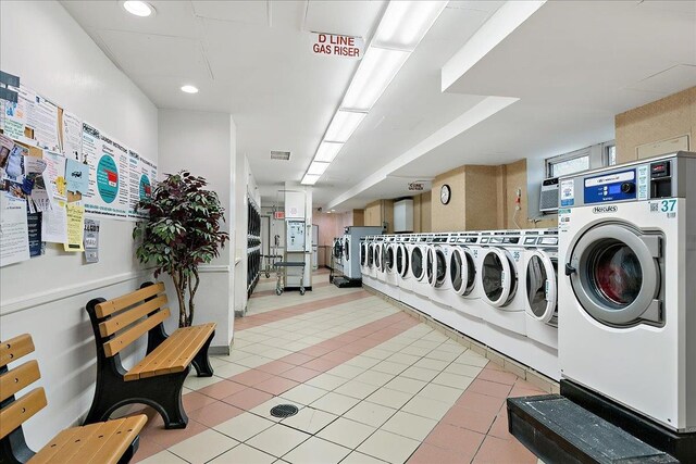 laundry area with light tile patterned floors and independent washer and dryer