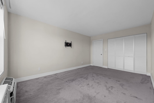 unfurnished bedroom with carpet flooring and a closet