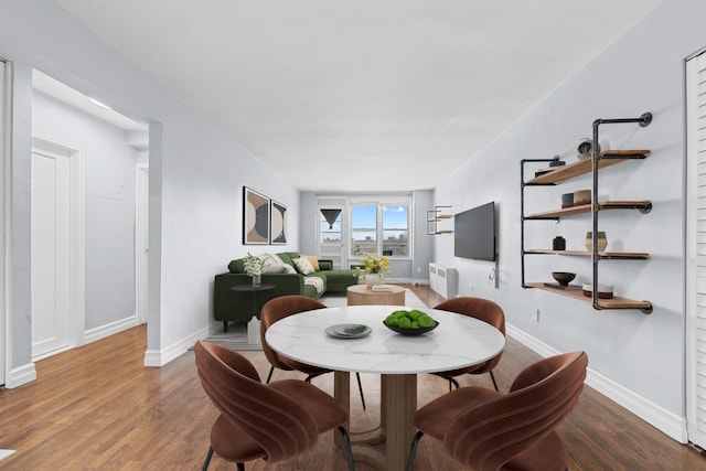 dining space with radiator and hardwood / wood-style flooring