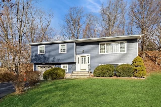 bi-level home with a garage and a front yard