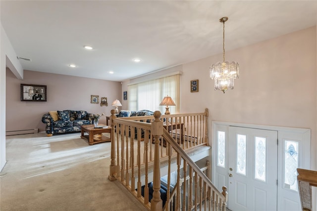 interior space featuring a chandelier, a healthy amount of sunlight, and a baseboard heating unit