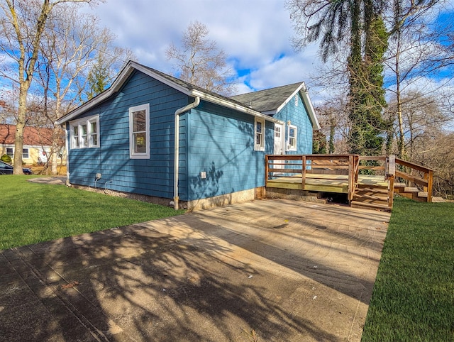 view of property exterior featuring a lawn and a wooden deck