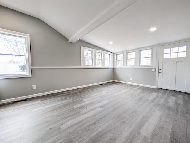 interior space featuring light hardwood / wood-style flooring and lofted ceiling with beams