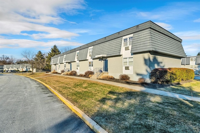 view of property exterior with a yard